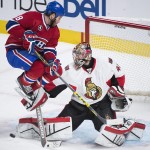 
              Ottawa Senators goaltender Craig Anderson makes as a save against the Montreal Canadiens as Canadiens' Brandon Prust looks for the rebound during the third period of Game 5 of a first-round NHL hockey playoff series, Friday, April 24, 2015, in Montreal. (Graham Hughes/The Canadian Press via AP)
            