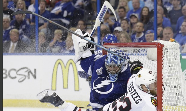 Chicago Blackhawks right wing Kris Versteeg (23) of Canada, collides with Tampa Bay Lightning goali...