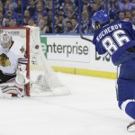 
              Chicago Blackhawks goalie Corey Crawford (50), left, blocks a shot by Tampa Bay Lightning right wing Nikita Kucherov (86), during the first period in Game 1 of the NHL hockey Stanley Cup Final in Tampa, Fla., Wednesday, June 3, 2015.  (AP Photo/Chris O'Meara)
            