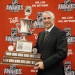 
              Calgary Flames coach Bob Hartley poses with the Jack Adams Award trophy after winning the award at the NHL Awards show Wednesday, June 24, 2015, in Las Vegas. (AP Photo/John Locher)
            