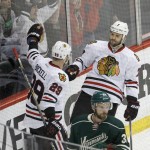 
              Chicago Blackhawks defenseman Brent Seabrook (7) and left wing Bryan Bickell (29) celebrate Seabrook's goal off Minnesota Wild goalie Devan Dubnyk as Wild defenseman Nate Prosser, front, looks away during the first period of Game 4 in the second round of the NHL Stanley Cup hockey playoffs Thursday, May 7, 2015, in St. Paul, Minn. (AP Photo/Ann Heisenfelt)
            
