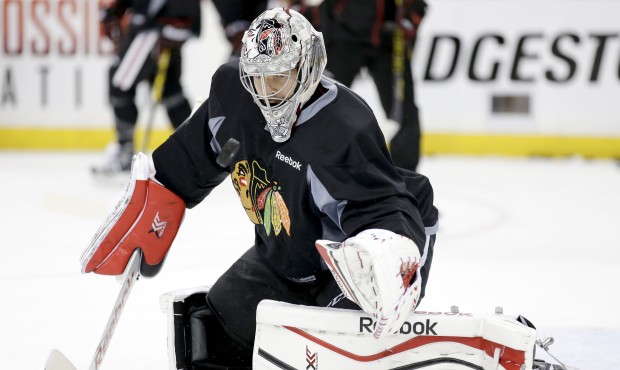 Chicago Blackhawks goalie Corey Crawford blocks a shot during practice at the NHL hockey Stanley Cu...
