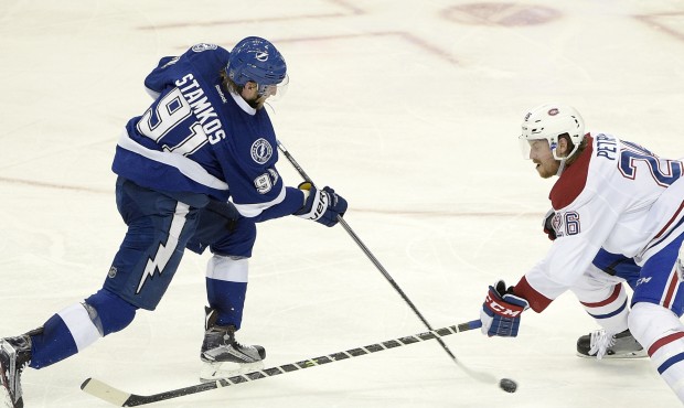 Tampa Bay Lightning center Steven Stamkos (91) makes a shot on goal past Montreal Canadiens defense...