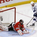 
              Chicago Blackhawks goalie Corey Crawford, left, makes a save on a shot by Tampa Bay Lightning's Steven Stamkos during the second period in Game 6 of the NHL hockey Stanley Cup Final series on Monday, June 15, 2015, in Chicago. (AP Photo/Charles Rex Arbogast)
            