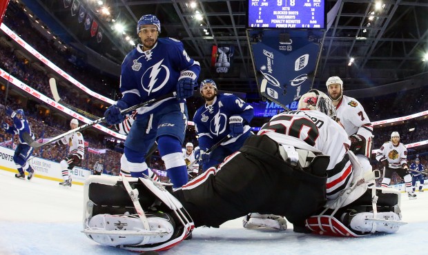 Tampa Bay Lightning right wing J.T. Brown, left, watches as Cedric Paquette’s shot goes by Ch...