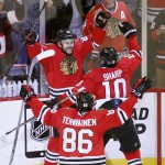 
              Chicago Blackhawks' Antoine Vermette, left, celebrates his goal with Patrick Sharp (10) and Teuvo Teravainen during the second overtime against the Anaheim Ducks in Game 4 of the Western Conference finals of the NHL hockey Stanley Cup playoffs, Saturday, May 23, 2015, in Chicago. The Blackhawks won 5-4. (AP Photo/Charles Rex Arbogast)
            