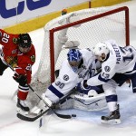 
              Chicago Blackhawks' Brandon Saad, left, reaches for a puck as Tampa Bay Lightning goalie Ben Bishop and Cedric Paquette, right, defend during the third period in Game 3 of the NHL hockey Stanley Cup Final on Monday, June 8, 2015, in Chicago. (AP Photo/Charles Rex Arbogast)
            