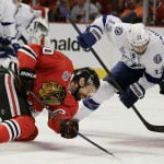 
              Chicago Blackhawks' Antoine Vermette, left, watches as Tampa Bay Lightning's Cedric Paquette handles the puck during the second period in Game 4 of the NHL hockey Stanley Cup Final Wednesday, June 10, 2015, in Chicago. (AP Photo/Nam Y. Huh)
            