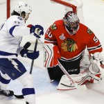 
              Chicago Blackhawks goalie Corey Crawford, right, deflects a puck as Tampa Bay Lightning's Brian Boyle watches during the third period in Game 4 of the NHL hockey Stanley Cup Final Wednesday, June 10, 2015, in Chicago. (AP Photo/Charles Rex Arbogast)
            