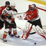 
              Chicago Blackhawks goalie Corey Crawford (50) hits Anaheim Ducks' Matt Beleskey (39) with his stick, as defenseman Duncan Keith (2) watches as the puck approaches the goal during the third period in Game 4 of the Western Conference finals of the NHL hockey Stanley Cup playoffs, Saturday, May 23, 2015, in Chicago. (AP Photo/Charles Rex Arbogast)
            