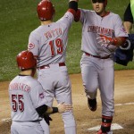 
              Cincinnati Reds' Eugenio Suarez, right, celebrates with Joey Votto (19) and Skip Schumaker (55) after hitting a two-run home run against the Chicago Cubs during the sixth inning of a baseball game Saturday, June 13, 2015, in Chicago. (AP Photo/Nam Y. Huh)
            