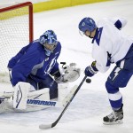 
              Tampa Bay Lightning goalie Ben Bishop, left, makes a save on a shot by left wing Ondrej Palat, of the Czech Republic, during NHL hockey practice at Amalie Arena for the Stanley Cup Finals, Tuesday, June 2, 2015, in Tampa, Fla. The Lightning will take on the Chicago Blackhawks in Game 1 on Wednesday.  (AP Photo/Chris O'Meara)
            