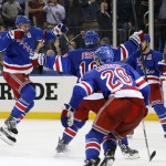 
              New York Rangers defenseman Ryan McDonagh, left, celebrates after scoring the winning goal in overtime during Game 5 in the second round of the NHL Stanley Cup hockey playoffs, Friday, May 8, 2015, in New York. The Rangers defeated the Capitals 2-1 to extend the series. (AP Photo/Kathy Willens)
            