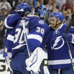 
              Tampa Bay Lightning goalie Ben Bishop (30) celebrates with right wing J.T. Brown (23) after the team defeated the Montreal Canadiens 4-1 during Game 6 of a second-round NHL Stanley Cup hockey playoff series Tuesday, May 12, 2015, in Tampa, Fla.  (AP Photo/Chris O'Meara)
            