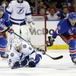 
              Tampa Bay Lightning defenseman Anton Stralman (6) hits the ice as he tries to maintain control of the puck against New York Rangers center J.T. Miller (10) during the third period of Game 7 of the Eastern Conference final during the NHL hockey Stanley Cup playoffs, Friday, May 29, 2015, in New York.  (AP Photo/Frank Franklin)
            