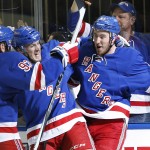 
              New York Rangers right wing Kevin Hayes (13) celebrates with center J.T. Miller (10) and defenseman Keith Yandle (93) after scoring a goal against the Washington Capitals during the second period of Game 7 of the Eastern Conference semifinals during the NHL hockey Stanley Cup playoffs, Wednesday, May 13, 2015, in New York. (AP Photo/Kathy Willens)
            