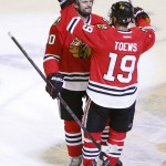 
              Chicago Blackhawks center Jonathan Toews (19) celebrates with Antoine Vermette after Vermette's goal against the Anaheim Ducks during the second overtime in Game 4 of the Western Conference finals of the NHL hockey Stanley Cup playoffs, Saturday, May 23, 2015, in Chicago. The Blackhawks won 5-4. (AP Photo/Charles Rex Arbogast)
            