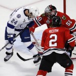 
              Chicago Blackhawks goalie Corey Crawford (50) keeps his eye on the puck along side teammate Duncan Keith (2) and Tampa Bay Lightning's Ryan Callahan (24) during the first period in Game 4 of the NHL hockey Stanley Cup Final Wednesday, June 10, 2015, in Chicago. (AP Photo/Charles Rex Arbogast)
            