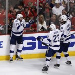 
              Tampa Bay Lightning's Cedric Paquette (13) is congratulated by J.T. Brown (23) and Victor Hedman (77) after scoring during the third period in Game 3 of the NHL hockey Stanley Cup Final against the Chicago Blackhawks on Monday, June 8, 2015, in Chicago. (AP Photo/Charles Rex Arbogast)
            