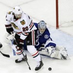 
              Tampa Bay Lightning goalie Andrei Vasilevskiy, right, blocks a shot by Chicago Blackhawks left wing Brandon Saad during the third period in Game 2 of the NHL hockey Stanley Cup Final on Saturday, June 6, 2015, in Tampa Fla. (AP Photo/John Raoux)
            