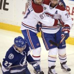 
              Montreal Canadiens defenseman Andrei Markov, right, is congratulated by left wing Max Pacioretty, center, after Markov scored, as Tampa Bay Lightning left wing Jonathan Drouin, left, skates away, during the first period of Game 4 of a second-round NHL Stanley Cup hockey playoff series in Tampa, Fla., Thursday, May 7, 2015. (AP Photo/Phelan M. Ebenhack)
            