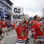 
              Chicago Blackhawks fan Eyle Bennett holds up a sign outside the arena before Game 2 of the NHL hockey Stanley Cup Final against the Tampa Bay Lightning on Saturday, June 6, 2015, in Tampa Fla. (AP Photo/John Raoux)
            