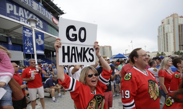 Chicago Blackhawks fan Eyle Bennett holds up a sign outside the arena before Game 2 of the NHL hock...