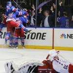 
              The New York Rangers celebrate their game winning overtime goal against the Washington Capitals in Game 7 of the Eastern Conference semifinals during the NHL hockey Stanley Cup playoffs, Wednesday, May 13, 2015, in New York. The Rangers won 2-1. (AP Photo/Kathy Willens)
            