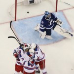 
              New York Rangers surround center J.T. Miller (10) after he scored against Tampa Bay Lightning goalie Ben Bishop (30) during the third period of Game 6 of the Eastern Conference finals in the NHL hockey Stanley Cup playoffs,Tuesday, May 26, 2015, in Tampa, Fla. The Rangers defeated the Lightning 7-3. (AP Photo/Chris O'Meara)
            