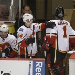 
              Calgary Flames' Jiri Hudler, center, of the Czech Republic, taps the shoulder of goalie Jonas Hiller, of Switzerland, after Hiller was relieved after giving up three goals to the Anaheim Ducks during the second period of Game 1 in the second round of the NHL Stanley Cup hockey playoffs, Thursday, April 30, 2015, in Anaheim, Calif. (AP Photo/Jae C. Hong)
            