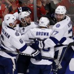 
              Tampa Bay Lightning's Cedric Paquette, second from left, is congratulated teammates Anton Stralman, left, J.T. Brown, and Victor Hedman, right, after scoring during the third period in Game 3 of the NHL hockey Stanley Cup Final against the Chicago Blackhawks on Monday, June 8, 2015, in Chicago. (AP Photo/Charles Rex Arbogast)
            