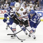 
              Chicago Blackhawks right wing Patrick Kane (88), middle, tries to move the puck away from Tampa Bay Lightning right wing Nikita Kucherov (86), left, of Russia and center Valtteri Filppula (51) of Finland, during the second period in Game 1 of the NHL hockey Stanley Cup Final in Tampa, Fla., Wednesday, June 3, 2015.  (AP Photo/Chris O'Meara)
            