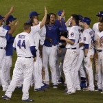 
              Chicago Cubs' Starlin Castro, center, celebrate with teammates after hitting the game-winning single during the ninth inning of a baseball game against the Cincinnati Reds on Saturday, June 13, 2015, in Chicago. The Cubs won 4-3. (AP Photo/Nam Y. Huh)
            