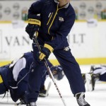 
              FILE - In a Sept. 12, 2013, file photo Nashville Predators assistant coach Phil Housley passes pucks during NHL hockey training camp in Nashville, Tenn.  Housley is among the seven newcomers in the Hockey Hall of Fame. (AP Photo/Mark Humphrey, file )
            