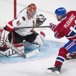 
              Ottawa Senators goaltender Craig Anderson makes a save on Montreal Canadiens' Tomas Plekanec during the second period of Game 5 of a first-round NHL hockey playoff series, Friday, April 24, 2015, in Montreal. (Graham Hughes/The Canadian Press via AP)
            