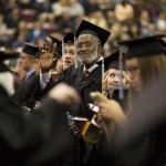 
              Former University of Minnesota and Pro Football Hall of Famer Bobby Bell waves to his family as he waits to get his diploma, Thursday, May 14, 2015, at Mariucci Arena at the University of Minnesota in Minneapolis. Fifty-two years after he left campus for pro football, Bell returned to earn his degree in parks, recreation and leisure studies and walk in graduation ceremonies on Thursday. (Renee Jones Schneider/Star Tribune via AP)  MANDATORY CREDIT; ST. PAUL PIONEER PRESS OUT; MAGS OUT; TWIN CITIES LOCAL TELEVISION OUT
            