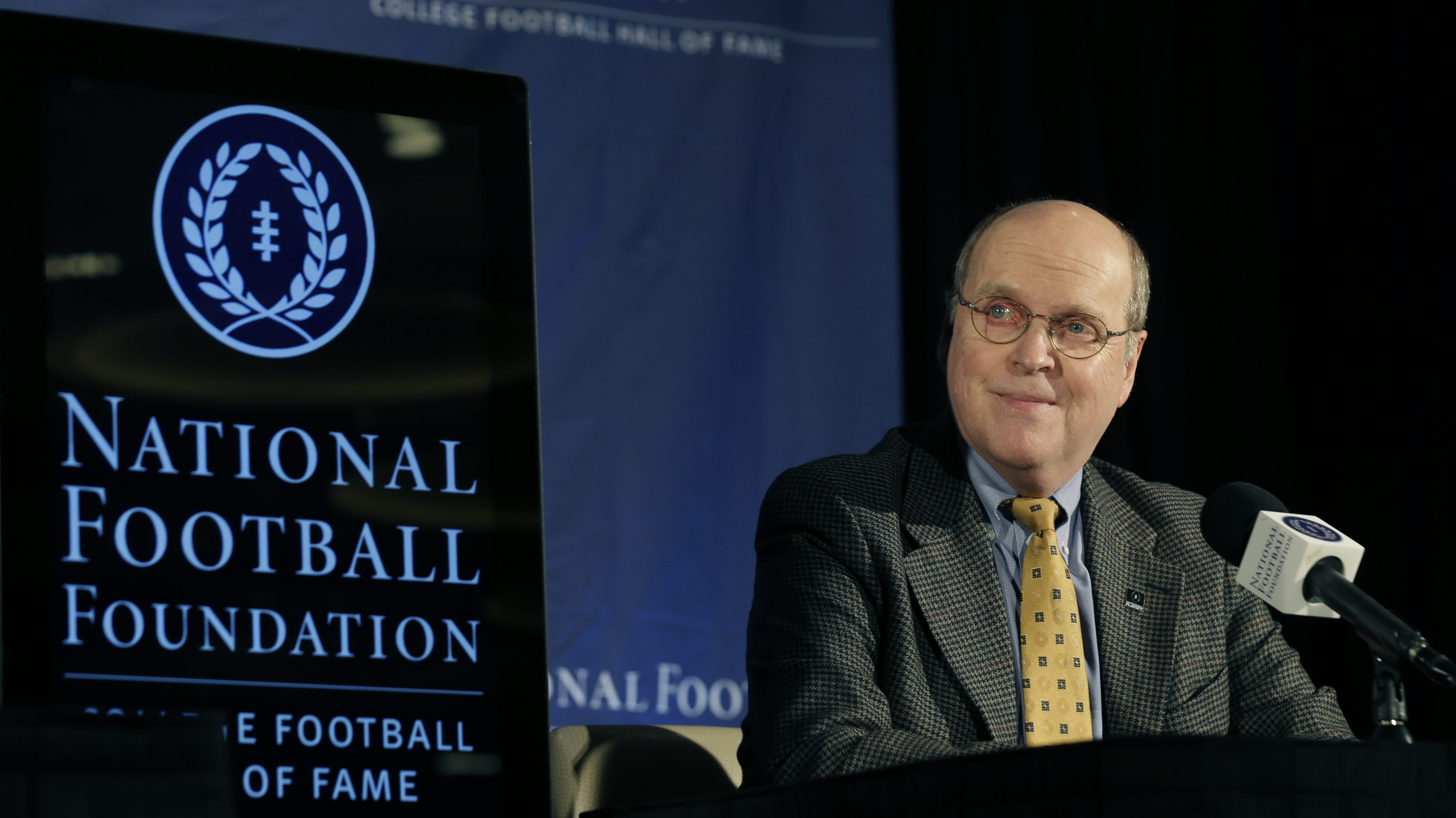 College Football Playoff executive director Bill Hancock sits on stage before a news conference ann...
