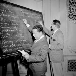 
              FILE - In this April 18, 1943, file photo, Fred Mandel, foreground, president of the Detroit Lions, and Charles "Chile" Walsh, assistant coach of the Cleveland Rams, look over prospects at the player draft of the NFL in Chicago. The NFL draft is back in the City of Big Shoulder Pads for a seventh time beginning Thursday, April 30, 2015, expecting a much warmer reception than it got nearly 80 years ago from the very first pick in its very first draft. (AP Photo/Harry L. Hall, File)
            