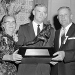 
              FILE - In this Dec. 12, 1957, file photo, John Crow, Texas A&M halfback, center, and his parents, Mr. and Mrs. Harry Crow of Springhill, La., hold Heisman Memorial Trophy award to Crow as the outstanding college football  player of 1957 at dinner at the Downtown Athletic Club in New York. Crow, the bruising running back who won the 1957 Heisman Trophy with Texas A&M before a Pro Bowl career in the NFL, died Wednesday night, June 17, 2015, surrounded by his family, Texas A&M said.  He was 79. (AP Photo/File)
            