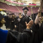 
              Former University of Minnesota and Pro Football Hall of Famer Bobby Bell gets a high-five from a professor as he walks in the procession, Thursday, May 14, 2015, at Mariucci Arena at the University of Minnesota in Minneapolis. Fifty-two years after he left campus for pro football, Bell returned to earn his degree in parks, recreation and leisure studies and walk in graduation ceremonies on Thursday. (Renee Jones Schneider/Star Tribune via AP)  MANDATORY CREDIT; ST. PAUL PIONEER PRESS OUT; MAGS OUT; TWIN CITIES LOCAL TELEVISION OUT
            