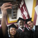 
              Desiree McGinley, left, and Andrew Otis, right, take a selfie with former Gophers great and Pro Football Hall of Famer Bobby Bell as they line up for the procession before graduating college, Thursday, May 14, 2015, at Mariucci Arena at the University of Minnesota in Minneapolis. Fifty-two years after he left campus for pro football, Bell returned to earn his degree in parks, recreation and leisure studies and walk in graduation ceremonies on Thursday. (Renee Jones Schneider/Star Tribune via AP)  MANDATORY CREDIT; ST. PAUL PIONEER PRESS OUT; MAGS OUT; TWIN CITIES LOCAL TELEVISION OUT
            