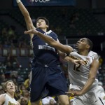               George Washington forward Yuta Watanabe, top left, shoots a layup while being defended by Wichita State forward Darius Carter (12) in the first half of an NCAA college basketball game at the Diamond Head Classic on Thursday, Dec. 25, 2014, in Honolulu. (AP Photo/Eugene Tanner)
            