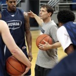 
              In this recent photo provided by the University of Nevada, Nevada coach Eric Musselman directs his players during his first NCAA college basketball practice in Reno, Nev. Musselman learned about running a Division I program from his father and during stops at two schools as an assistant. But once he was named the head coach at Nevada, Musselman found out there's a lot more to the job than he imagined.  (John Byrne, University of Nevada via AP)
            