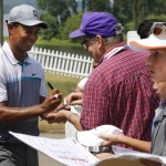 
              Tiger Woods signs autographs after a practice round for the Quicken Loans National golf tournament at the Robert Trent Jones Golf Club in Gainesville, Va., Tuesday, July 28, 2015.  (AP Photo/Steve Helber)
            