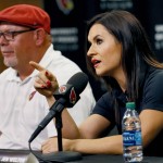 Arizona Cardinals training camp coach Dr. Jen Welter speaks as head coach Bruce Arians listens, Tuesday, July 28, 2015, at the teams' training facility in Tempe, Ariz. Welter is believed to be the first female to hold a coaching position of any kind in the NFL and will be member of the Cardinals coaching staff throughout training camp and the preseason, working with inside linebackers. (AP Photo/Matt York)