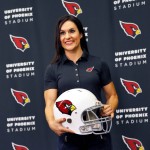 Arizona Cardinals training camp football coach Dr. Jen Welter poses for photographers after being introduced, Tuesday, July 28, 2015, at the teams' training facility in Tempe, Ariz. Welter is believed to be the first female to hold a coaching position of any kind in the NFL and will be member of the Cardinals coaching staff throughout training camp and the preseason, working with inside linebackers. (AP Photo/Matt York)