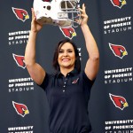 Arizona Cardinals training camp coach Dr. Jen Welter poses for photographers after being introduced, Tuesday, July 28, 2015, at the teams' training facility in Tempe, Ariz. Welter is believed to be the first female to hold a coaching position of any kind in the NFL and will be member of the Cardinals coaching staff throughout training camp and the preseason, working with inside linebackers. (AP Photo/Matt York)