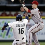 Arizona Diamondbacks second baseman Chris Owings reaches for the ball as Seattle Mariners' Austin Jackson slides toward second base in the third inning of a baseball game, Tuesday, July 28, 2015, in Seattle. Jackson was out on the fielder's choice, with Kyle Seager safe at first. (AP Photo/Elaine Thompson)