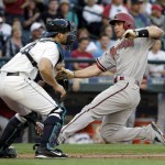 Arizona Diamondbacks' Paul Goldschmidt, right, slides safely toward home as Seattle Mariners catcher Mike Zunino waits for the ball in the third inning of a baseball game Tuesday, July 28, 2015, in Seattle. (AP Photo/Elaine Thompson)
